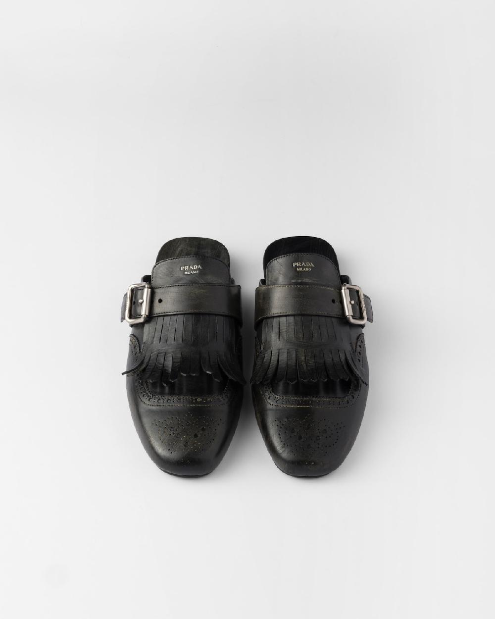 Prada Mules Shuffle de piel con flecos En oferta