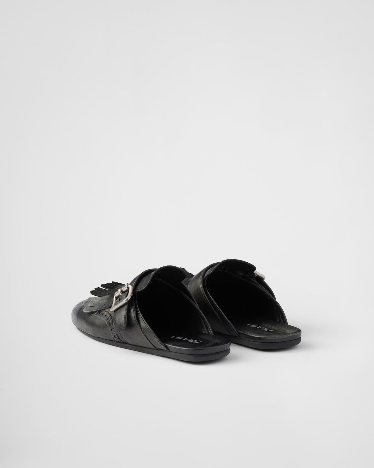 Prada Mules Shuffle de piel con flecos En oferta