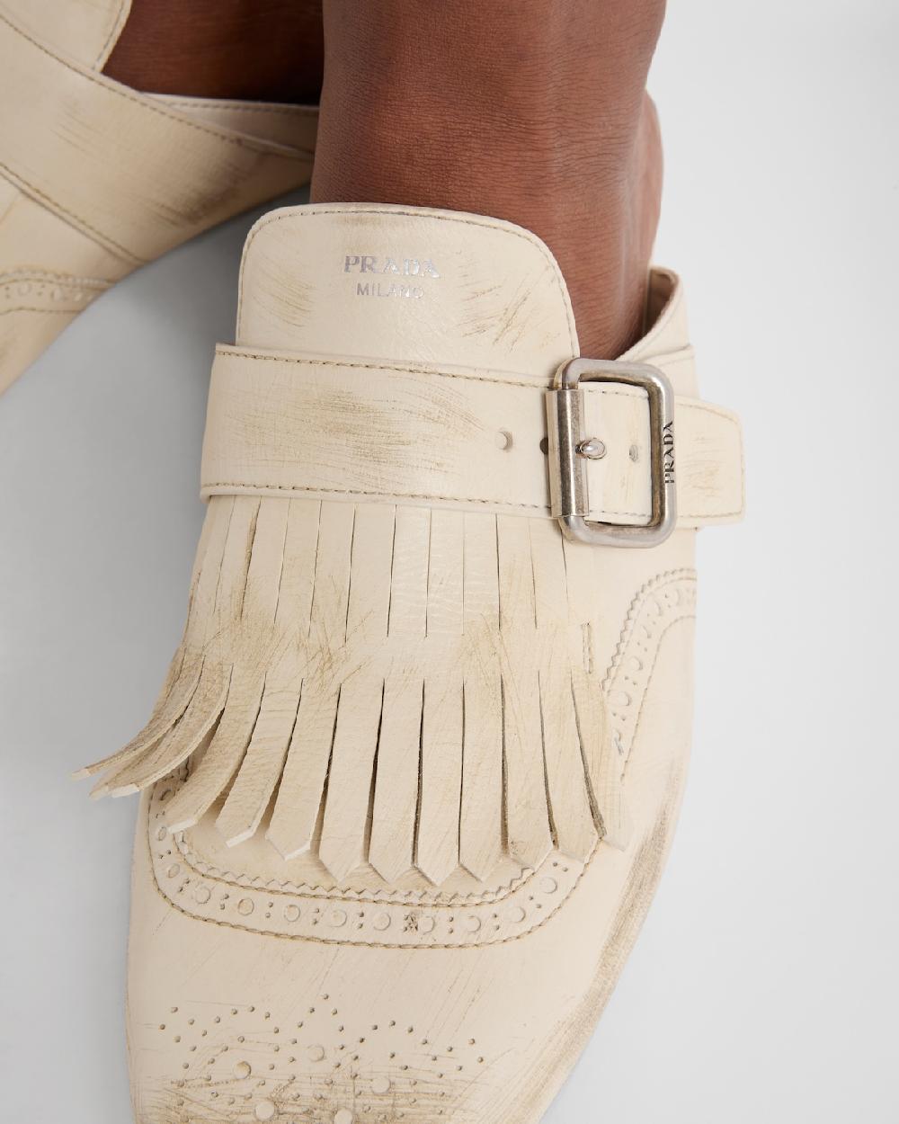 Prada Mules Shuffle de piel con flecos Descuentos del mes
