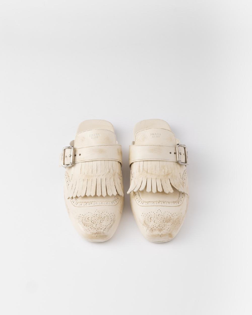 Prada Mules Shuffle de piel con flecos Descuentos del mes