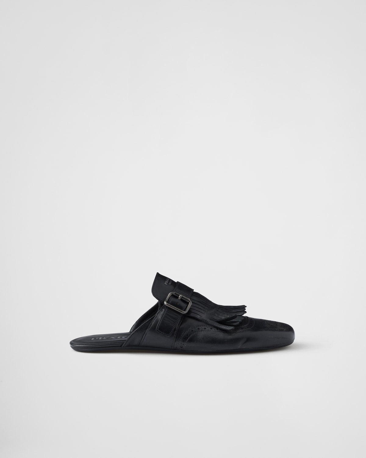 Prada Mules Shuffle de piel con flecos y correa de hebilla