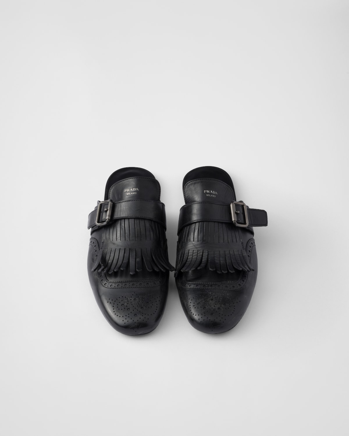 Prada Mules Shuffle de piel con flecos y correa de hebilla ÚLTIMAS EDICIONES